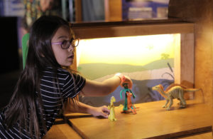 Girl doing stop motion animation with Gumby